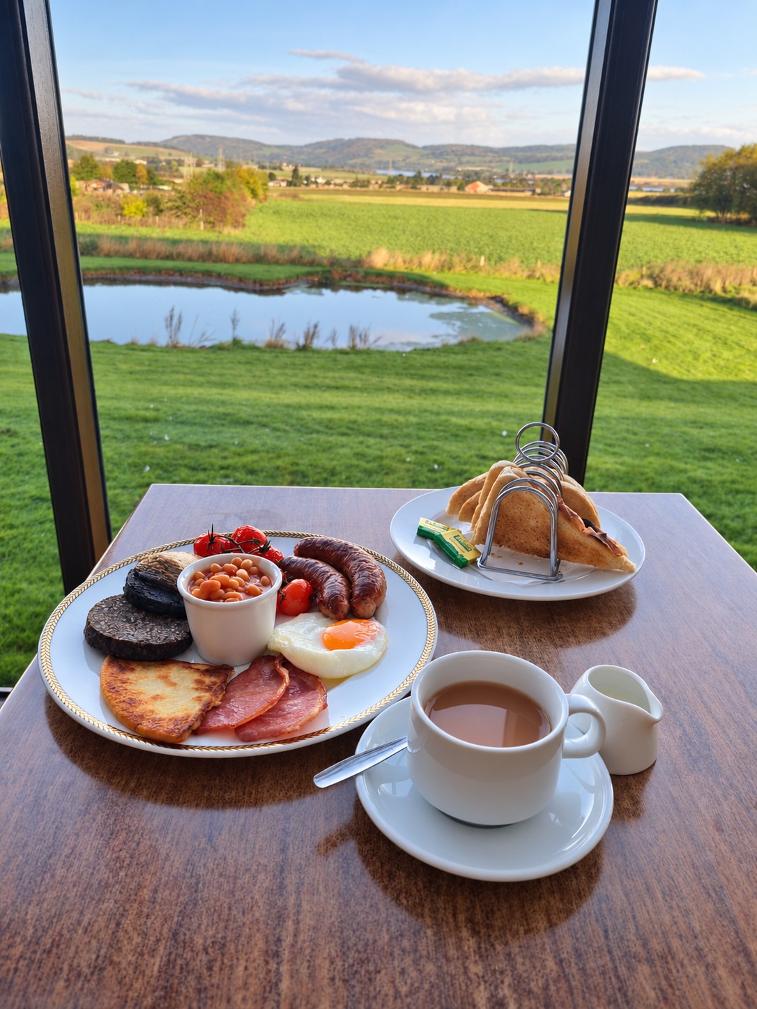 Breakfast and a cup of tea at Jamesfield overlooking the pond, fields and distant hills