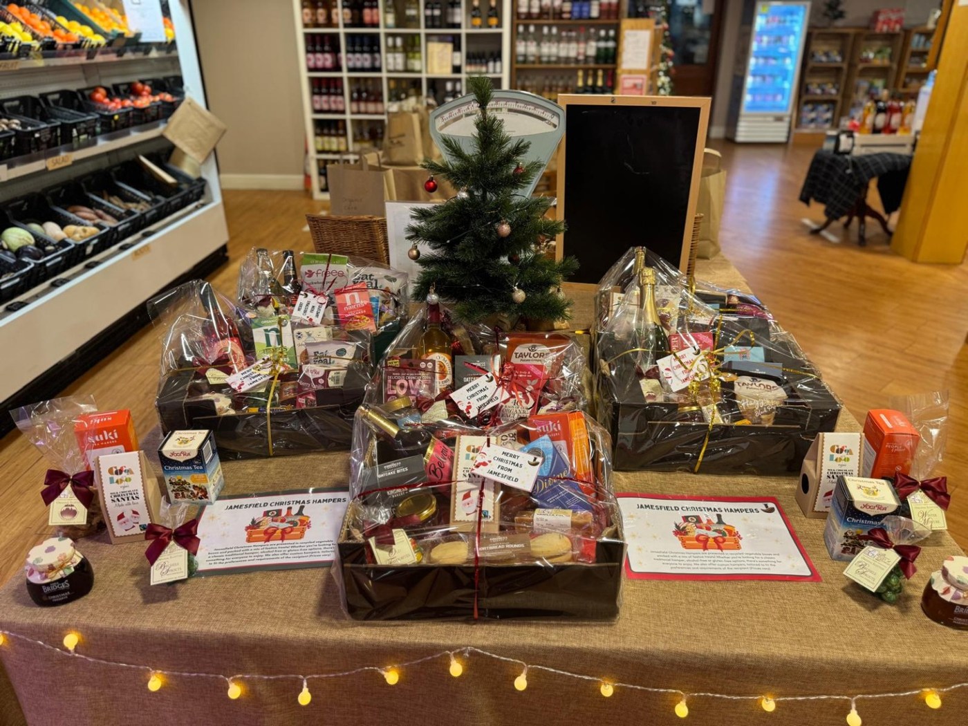 Jamesfield Christmas hampers wrapped and displayed around a Christmas tree in the farmshop