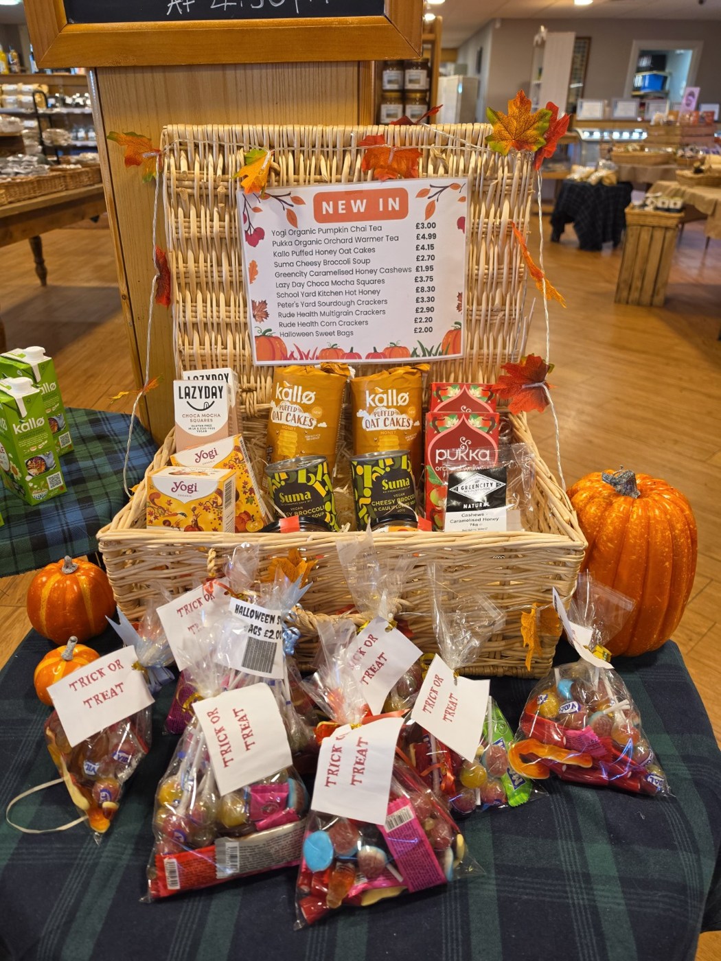 Autumn teas, snacks and Halloween sweet bags in a decorated wicker display